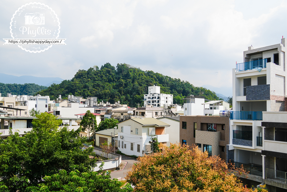 淺山民宿 Rolling Hills 頂樓景觀，俯瞰埔里市區與遠方山巒，景色迷人。